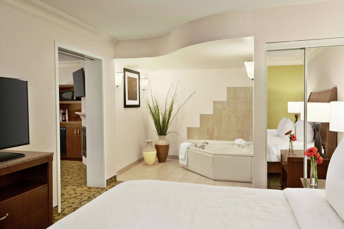one bedroom suite, one king bed, with jetted tub | bathroom | free toiletries, hair dryer, towels, soap