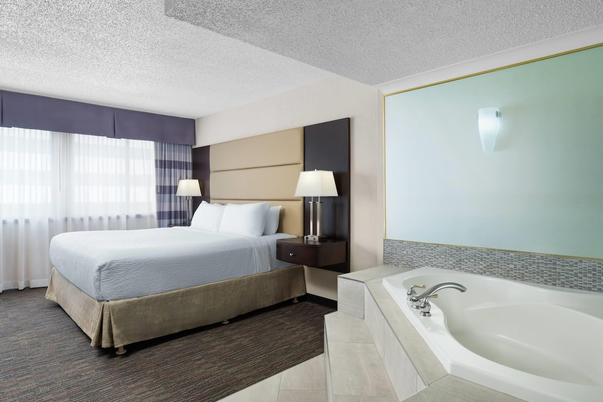 Premium Suite, 1 King Bed, Jetted Tub | In-room safe, desk, laptop workspace, blackout drapes