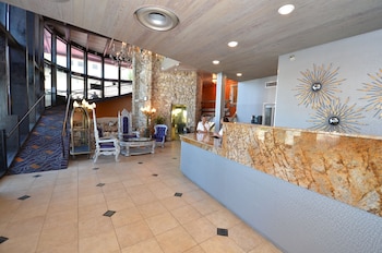 Experience the perfect blend of modern and traditional design in our spacious lobby, featuring a marble reception desk and comfortable seating area. at Sea Club Resort