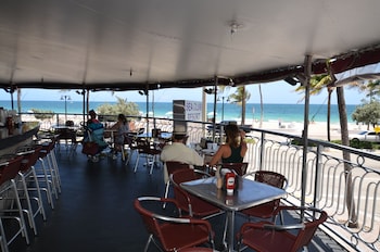 Enjoy meals with a view of the beach and sea from our outdoor dining area. at Sea Club Resort