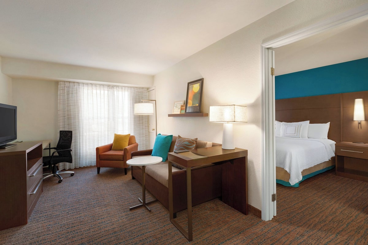 Premium bedding, desk, laptop workspace, blackout drapes