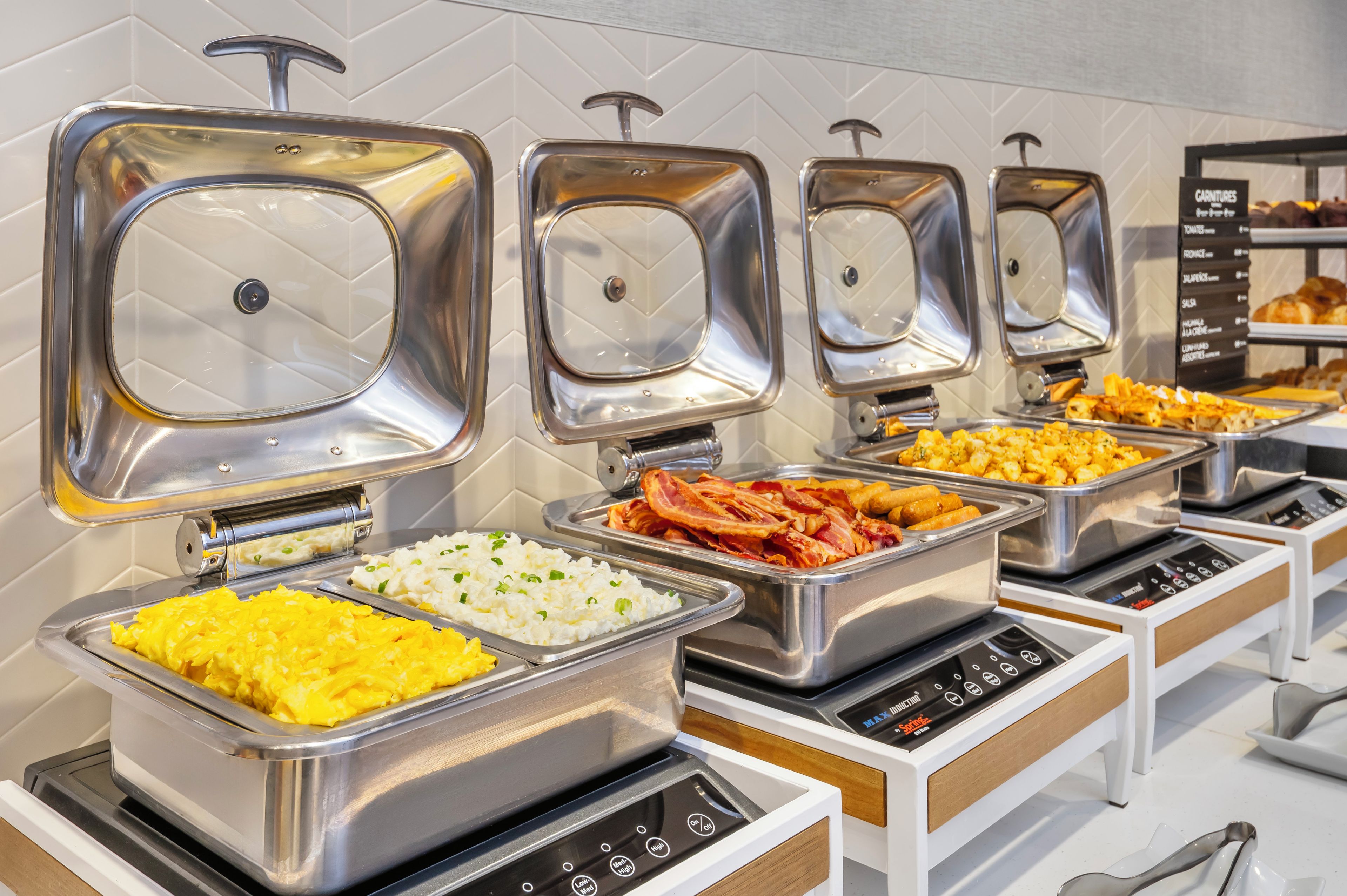 A buffet setup with various food items and a control panel.