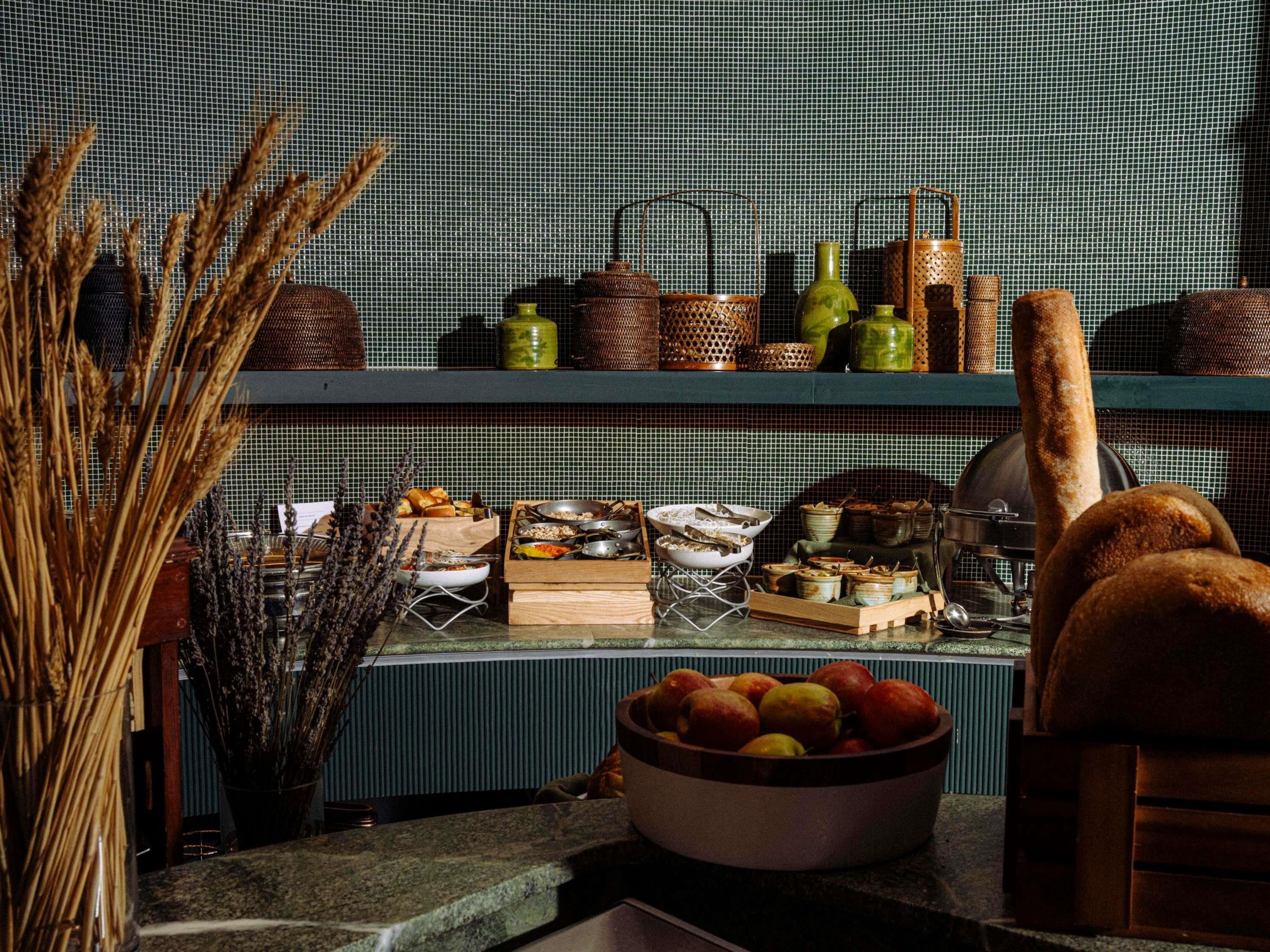 A kitchen counter with various food items and kitchenware.