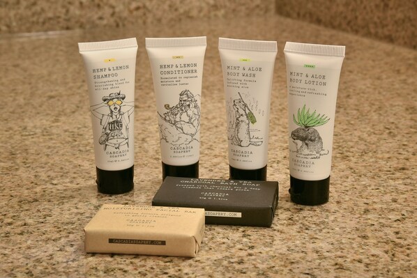 Four tubes of Cascadia Soapery products and a bar of soap on a countertop. - Red Lion Hotel Eureka (Eureka)