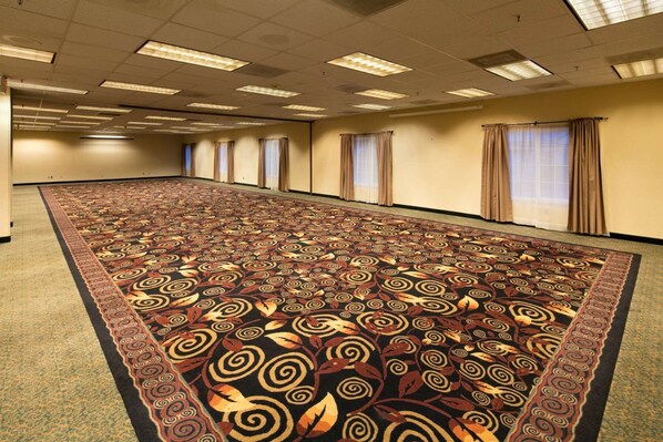 A large conference room with a patterned carpet, long tables, and windows with curtains. - Red Lion Hotel Eureka (Eureka)