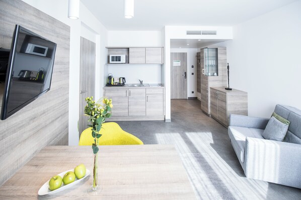 Executive Suite, Multiple Beds | Living area | LCD TV