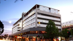 A multi-story hotel with a modern design, featuring a prominent 'NOVOTEL' sign. - Novotel Canberra (Canberra)