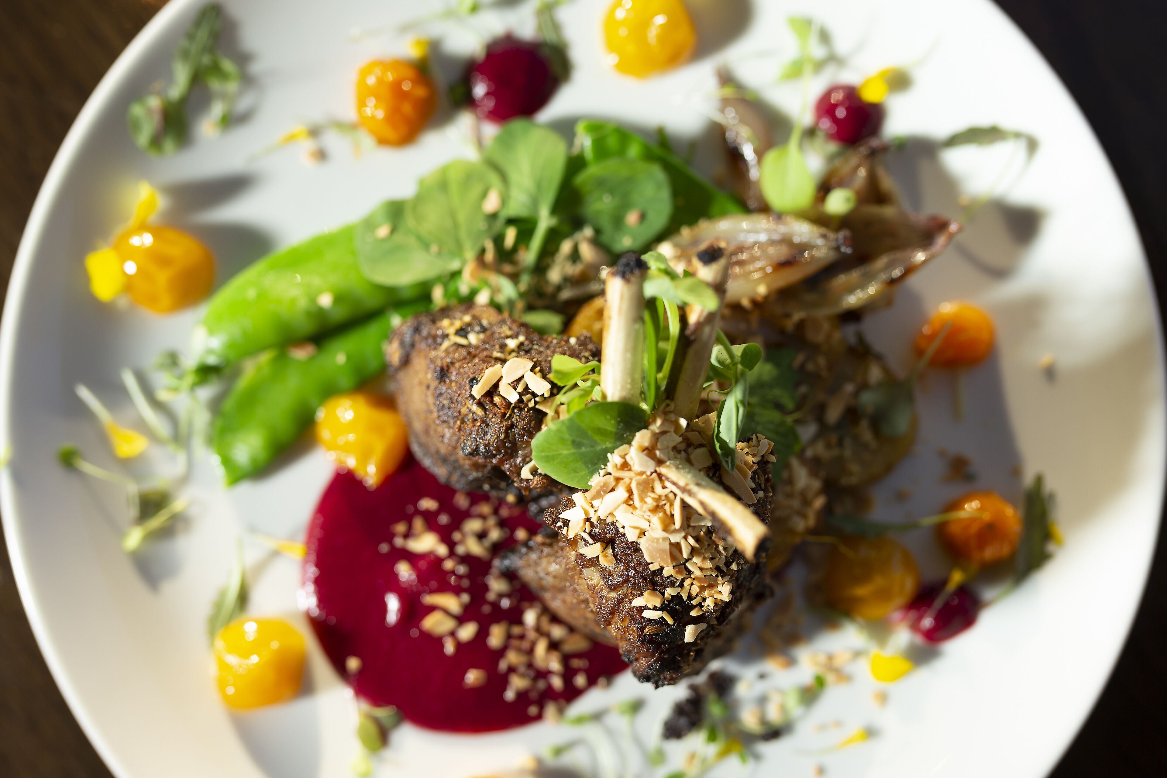 A plate of food with various vegetables and garnishes.