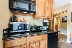 Deluxe Room, Kitchenette | Private kitchenette | Full-sized fridge, microwave, stovetop, coffee/tea maker