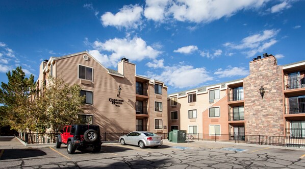 A multi-story apartment building with a sign reading "Carriage House 1040".