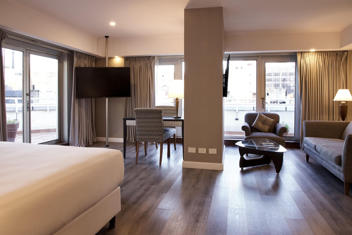 Suite, 1 King Bed, Balcony, Corner | Living area | 55-inch Smart TV with satellite channels