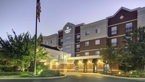 A multi-story hotel with a prominent 'Hyatt House' sign, a flagpole with an American flag, and a well-lit entrance. - HYATT house Philadelphia/Plymouth Meeting (East Norriton)