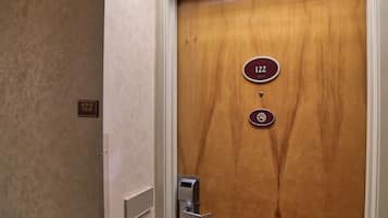 A wooden door with a number plate indicating room 122.