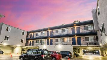 A multi-story motel with a parking garage.