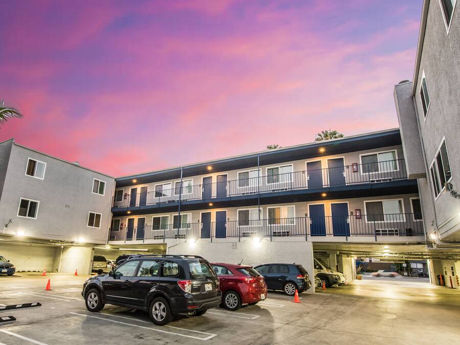 A multi-story motel with a parking garage.