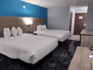 A hotel room with two beds, a desk, and a nightstand. - Baymont by Wyndham Duluth/Proctor/Spirit Mountain MN (Duluth)