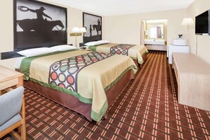 A hotel room with two beds, a desk, a chair, a television, and artwork on the walls.