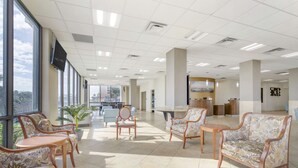 A spacious lobby with large windows, comfortable seating, and a reception area. - Best Western Corpus Christi (Corpus Christi)