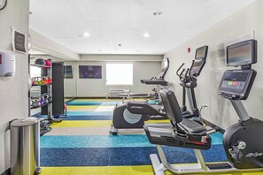 A gym with treadmills, elliptical machines, and weight equipment. - MainStay Suites (Mobile)