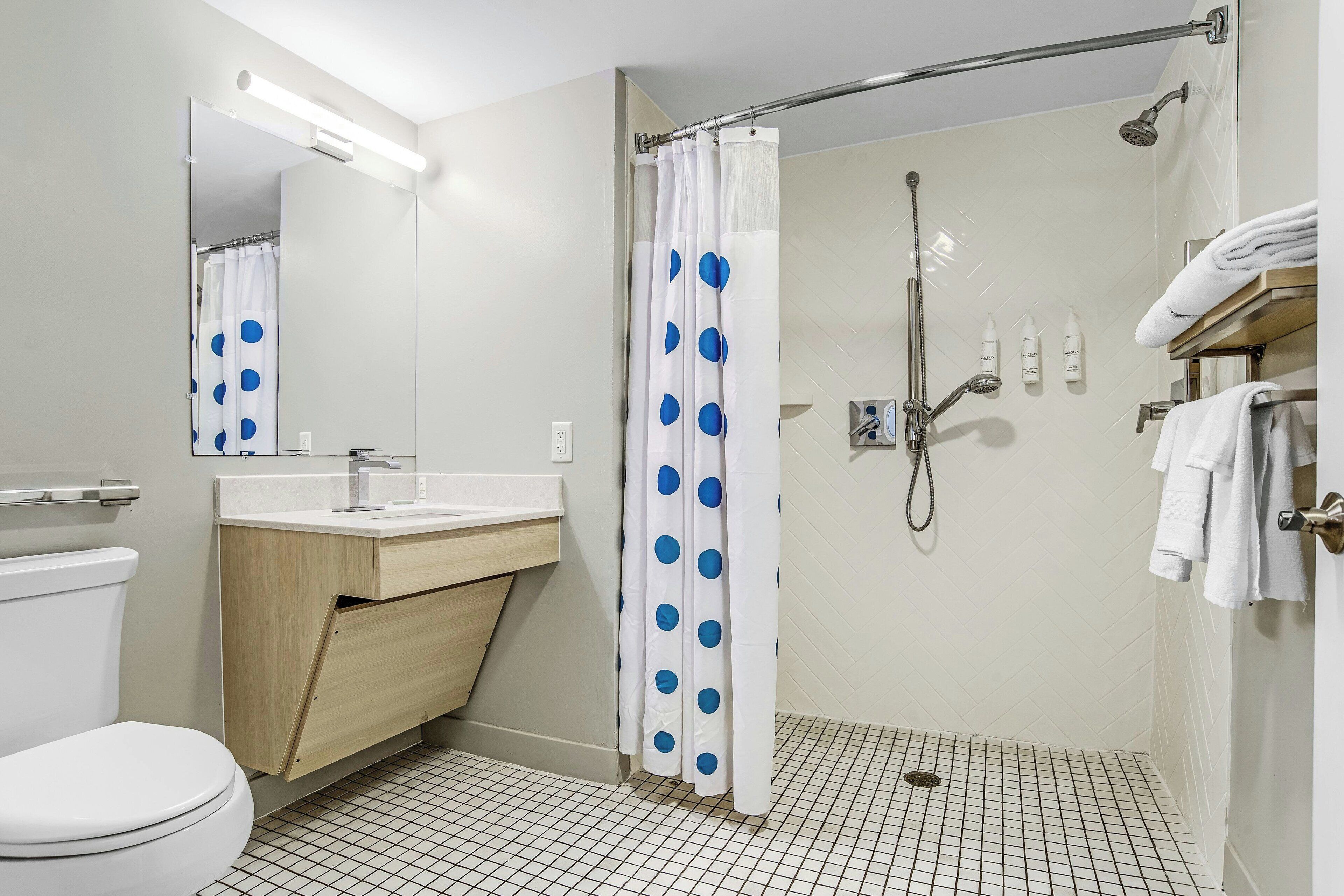 pillow-top beds, desk, laptop workspace, blackout curtains