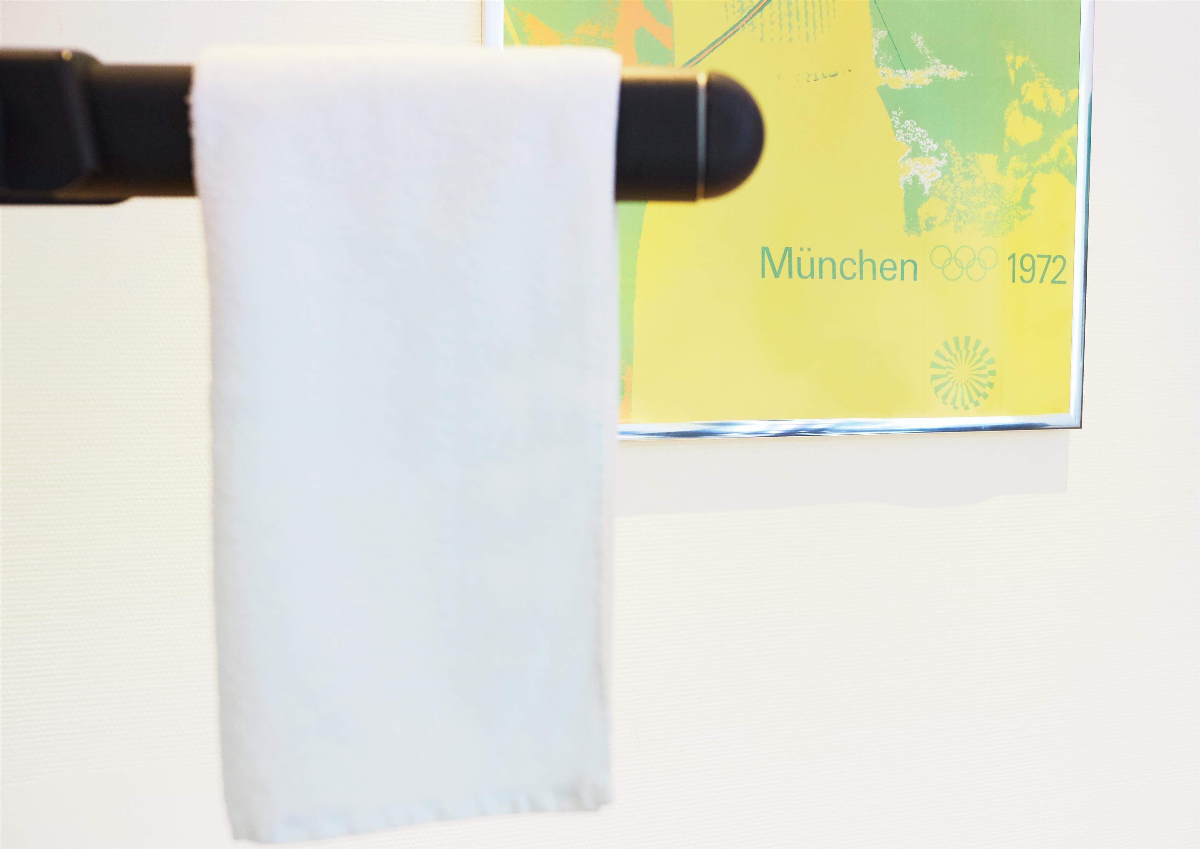 A towel hanging on a black towel rack.