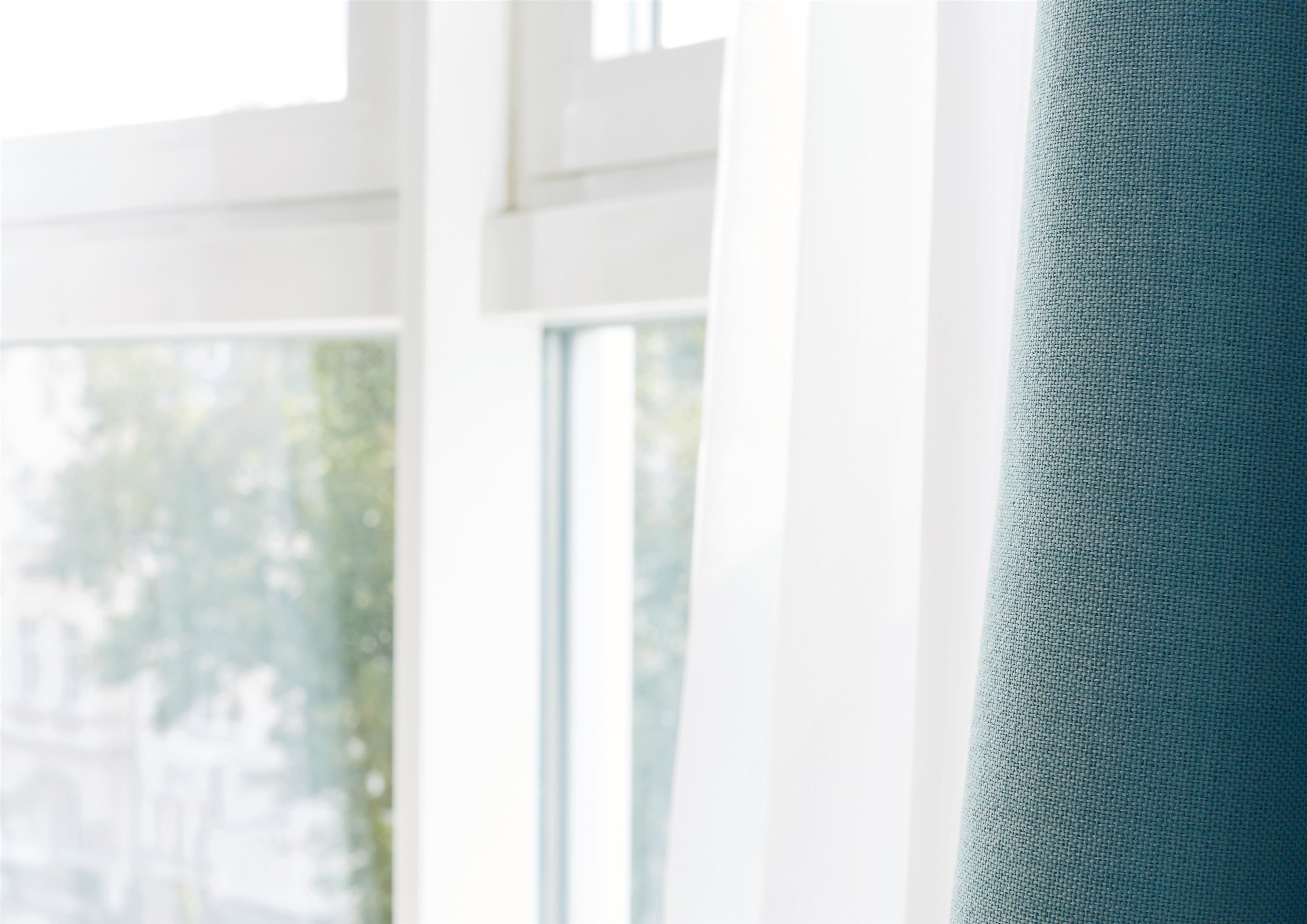 A window with a view of greenery outside.