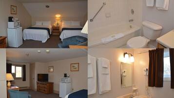 Habitación de hotel con dos camas, televisor, escritorio, microondas, refrigerador pequeño y baño con bañera, inodoro y lavabo.
