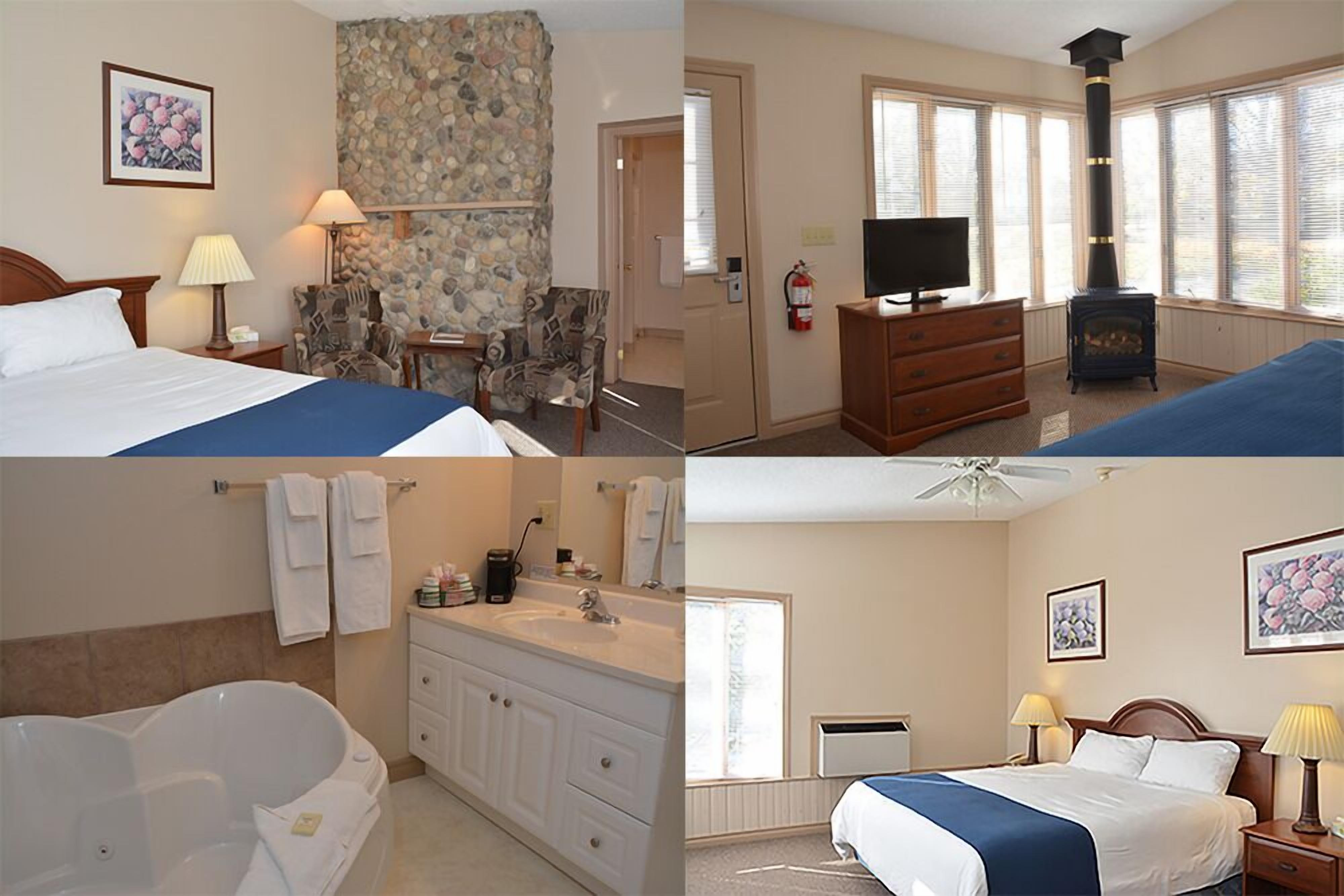 Habitación de hotel con cama, televisión, chimenea, baño con bañera y ducha.