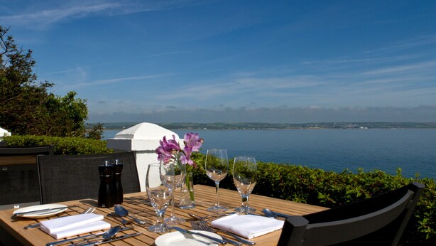 A table set for dining with a view of the sea. - Bayview Hotel (Ballycotton)