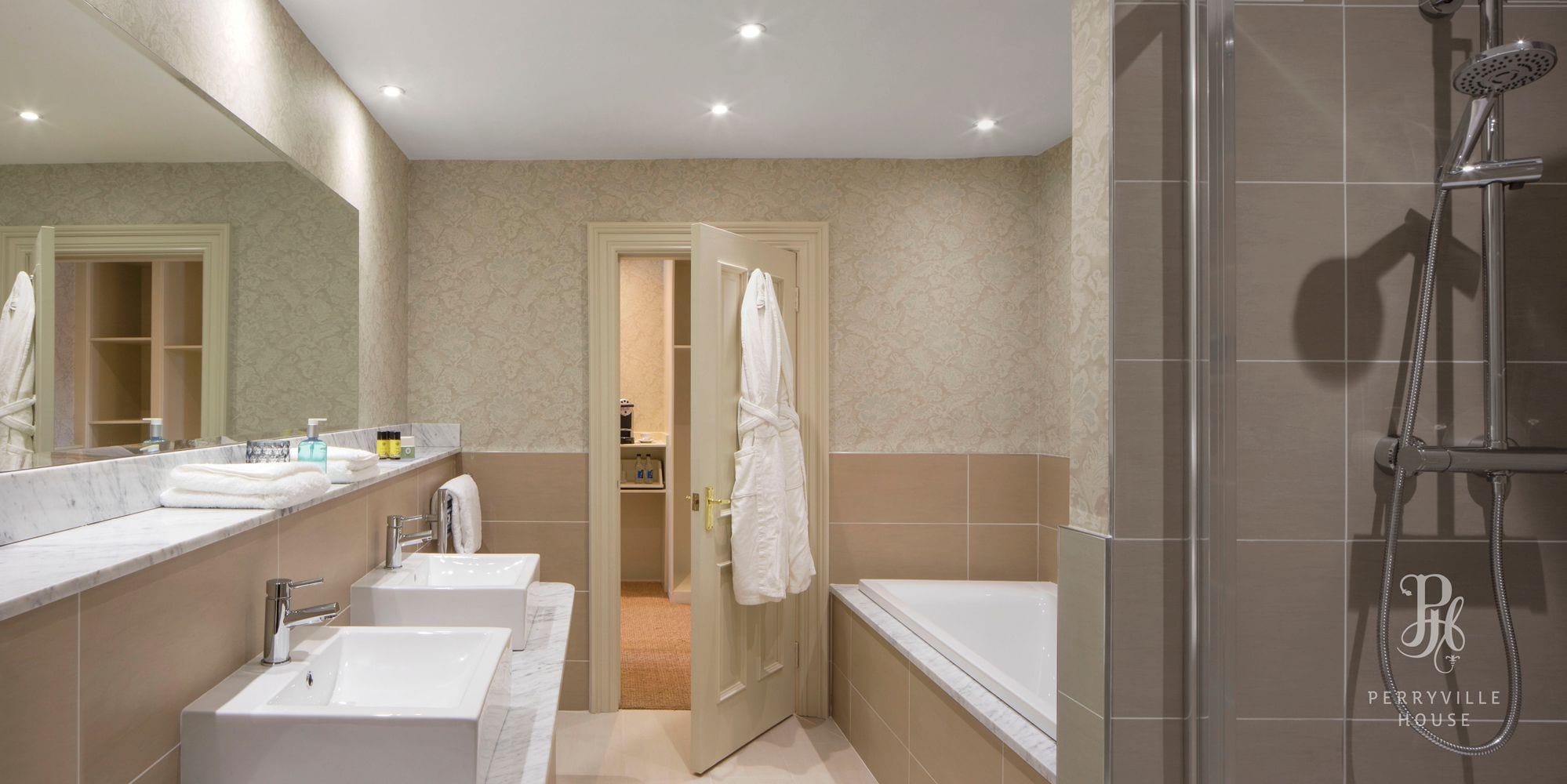 A modern bathroom with a walk-in shower, a double sink vanity, and a large mirror.