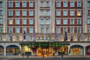 A hotel with a symmetrical facade, multiple windows, and a central entrance with a marquee. - DoubleTree by Hilton London West End (London)