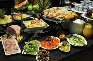A buffet with various food items including fruits, vegetables, pastries, and beverages. - DoubleTree by Hilton London West End (London)