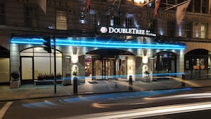 The exterior of the DoubleTree by Hilton hotel with a marquee sign, entrance, and potted plants. - DoubleTree by Hilton London West End (London)