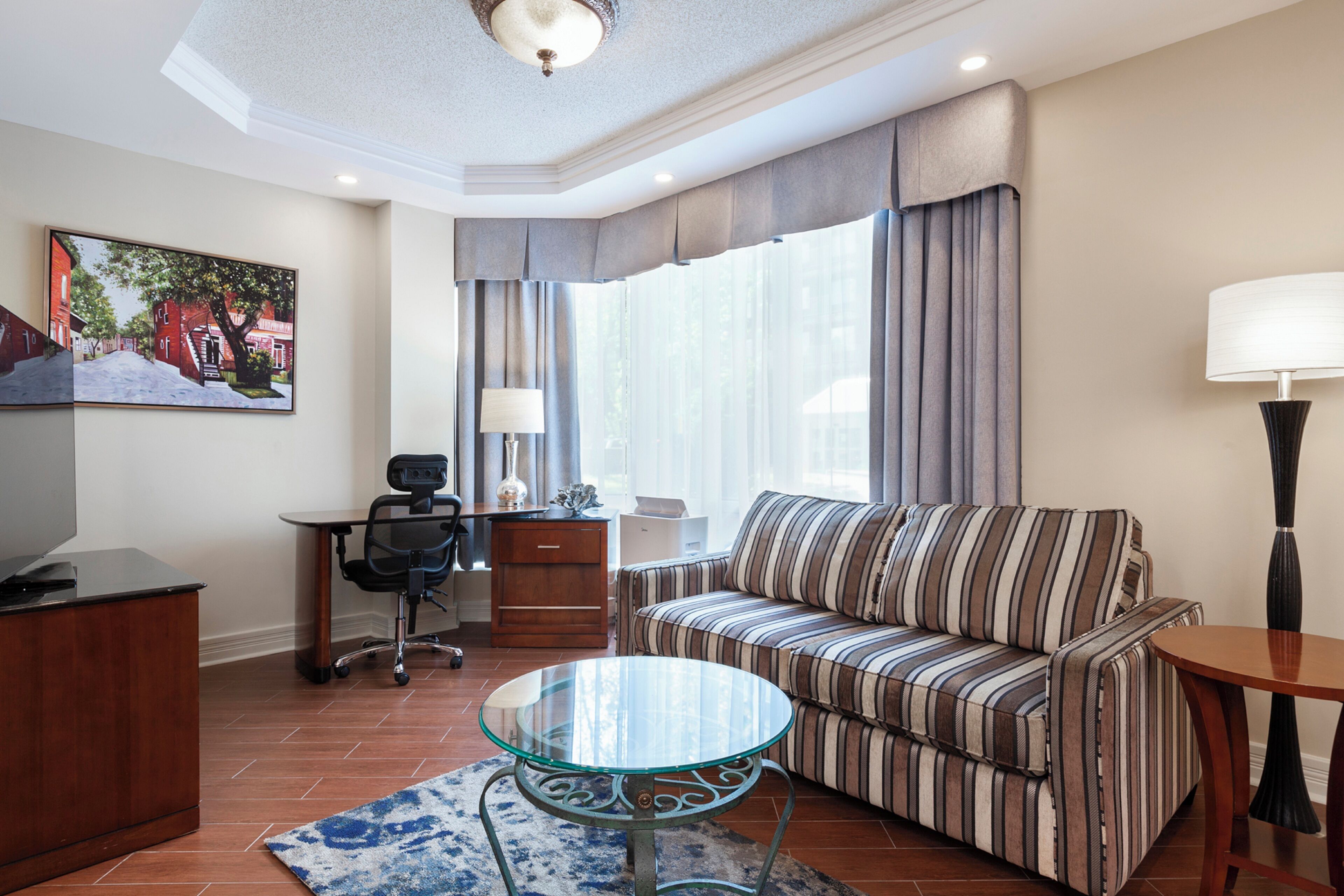 suite king room 127 | living area | 55-inch flat-screen tv with cable channels, tv, pay films