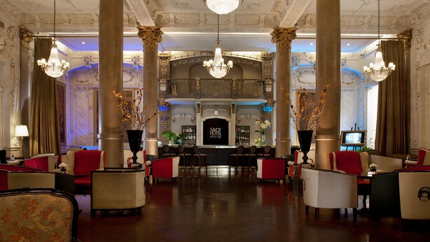 A grand lobby with ornate columns, chandeliers, and a bar area. - Savoy Hotel (Buenos Aires)