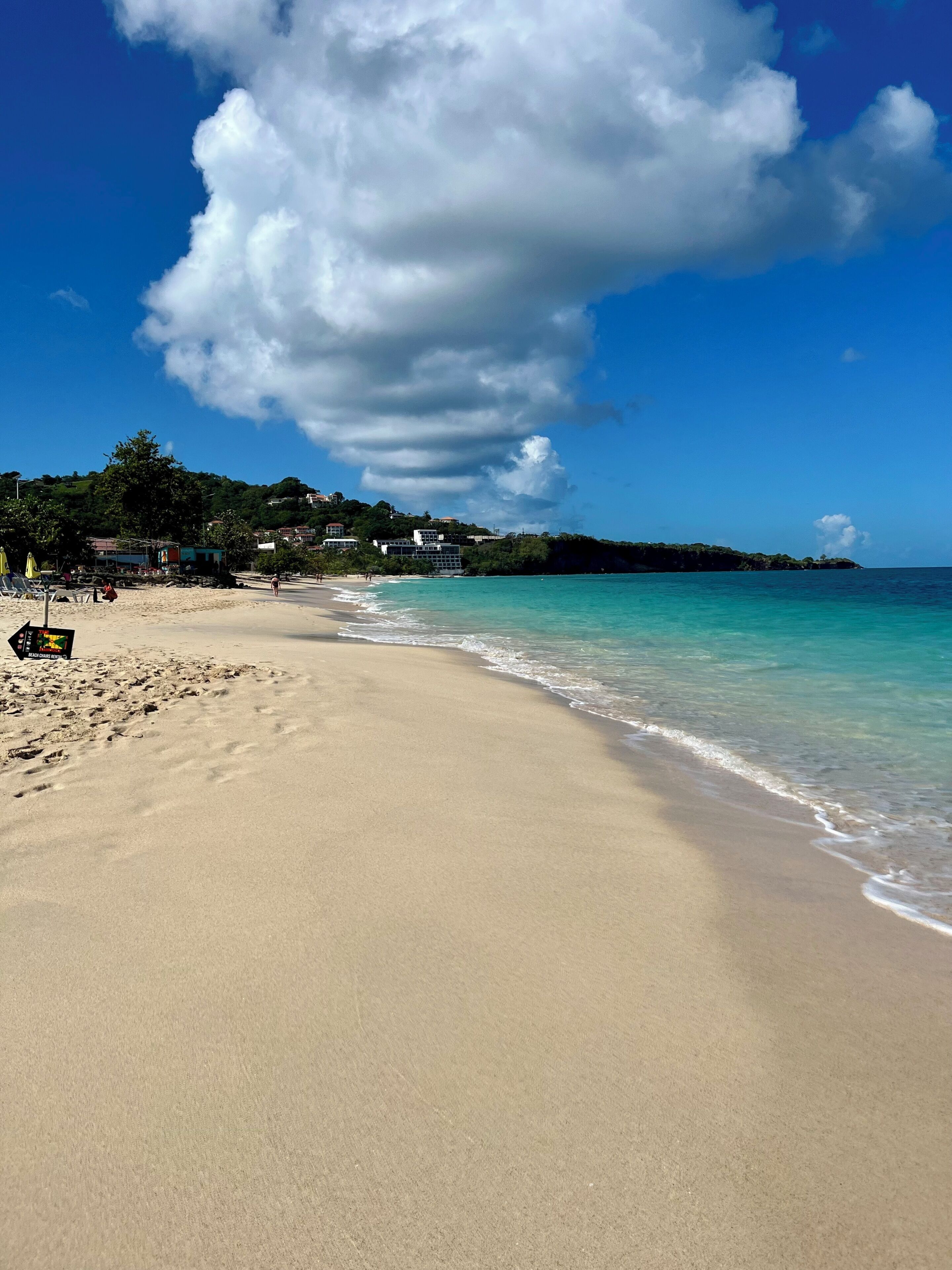 On the beach, white sand, sun-loungers, beach towels