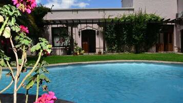 A swimming pool with a building in the background.