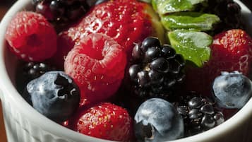 A bowl of mixed berries including raspberries, blackberries, and blueberries.