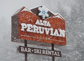 A sign for Alta Peruvian Lodge, indicating it is a bar and ski rental facility. - Alta Peruvian Lodge (Sandy)