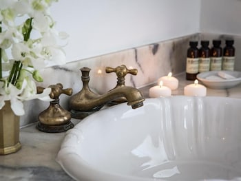 Hydromassage showerhead, designer toiletries, hair dryer, towels at Casa Faena Miami Beach