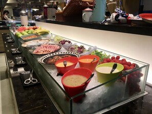 A buffet with various food items and utensils. - Island Pacific Hotel (Hong Kong)