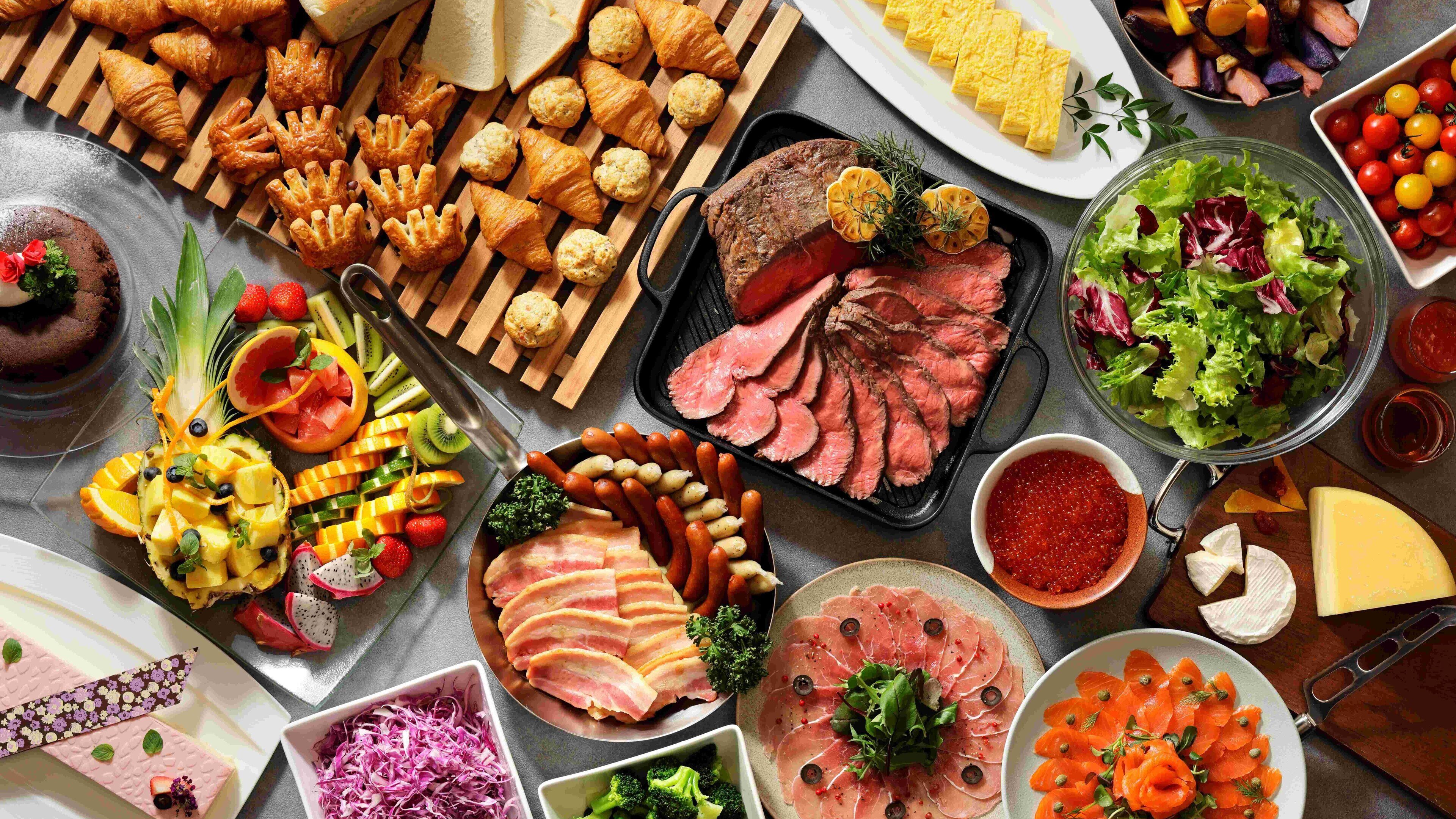 A variety of food items including pastries, meats, and salads.