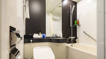 A modern bathroom with a toilet, sink, and bathtub.