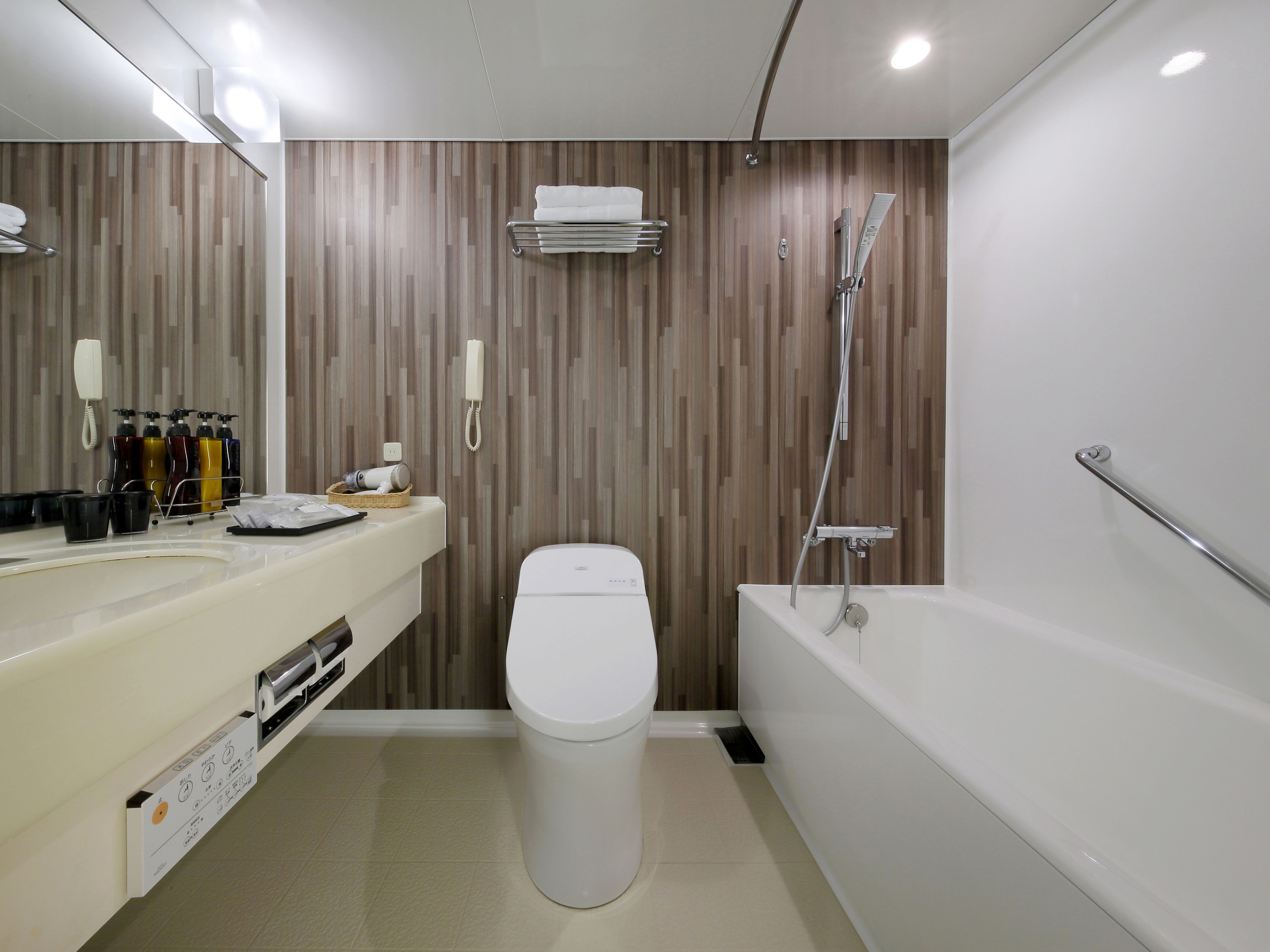 A modern bathroom with a toilet, sink, and bathtub.