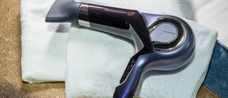 A hairdryer with a digital display on a textured surface.