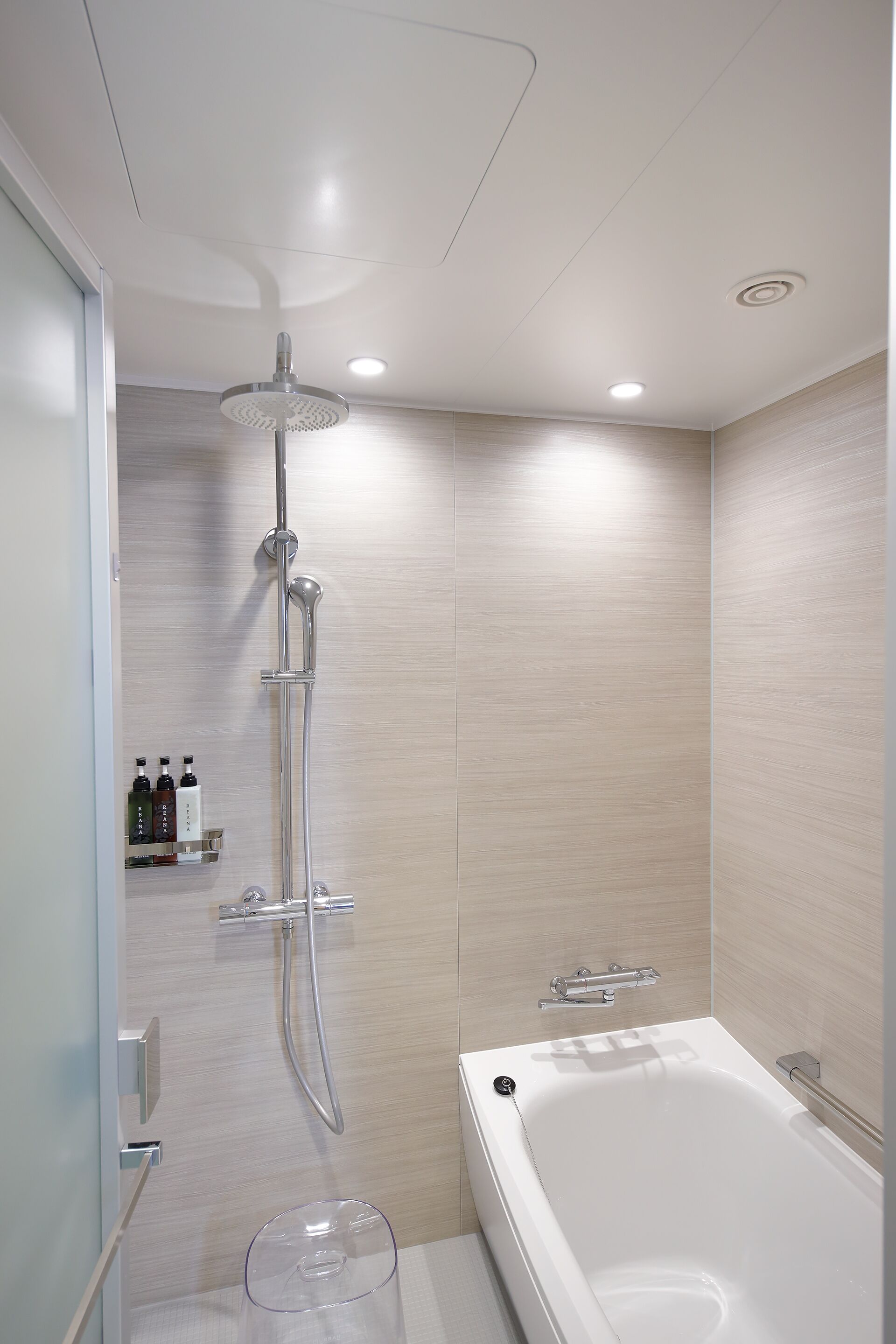 A modern bathroom with a shower, a bathtub, and a toilet.