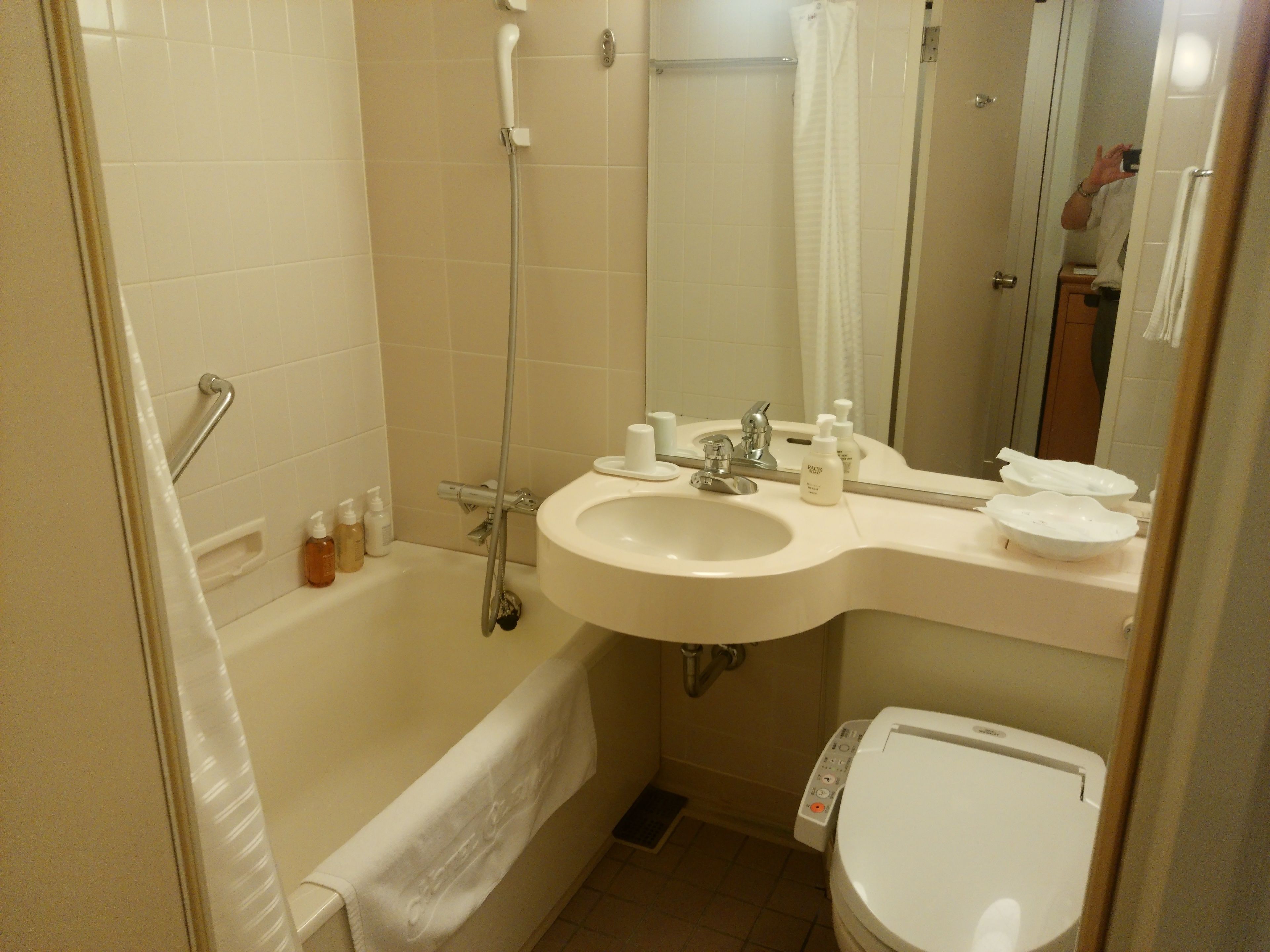 A bathroom with a bathtub, a sink, a toilet, and a shower.