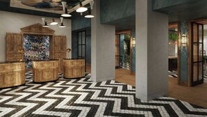 A lobby with a herringbone patterned floor, wooden reception desks, and a ceiling mural. - Hyde & Seek, London Hyde Park, a Tribute Portfolio Hotel (London)