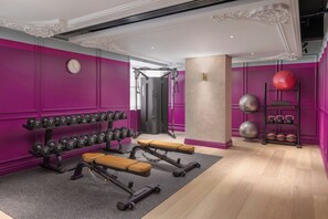 A gym with weightlifting equipment, benches, and exercise balls. - Hyde & Seek, London Hyde Park, a Tribute Portfolio Hotel (London)