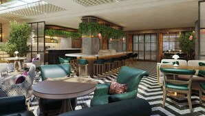 A modern lounge area with green upholstered seating, a bar, and a large window providing natural light. - Hyde & Seek, London Hyde Park, a Tribute Portfolio Hotel (London)